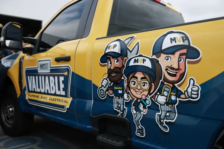 A yellow and blue utility truck features cartoon graphics of three workers in MVP uniforms and a "Most Valuable" company logo for plumbing, HVAC, and electrical services.