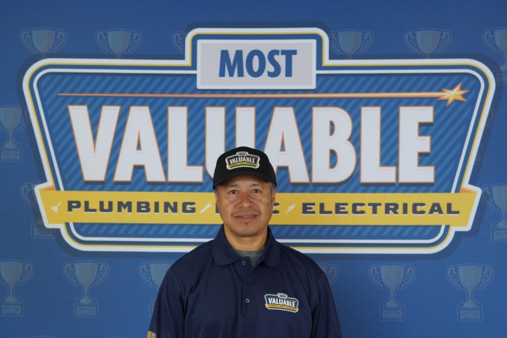 Meet the team: A man in a "Most Valuable" uniform stands in front of a backdrop that reads "Most Valuable Plumbing Electrical," with trophy icons in the background.
